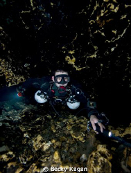 Cave diver sidemounting inside of Florida cave. by Becky Kagan 